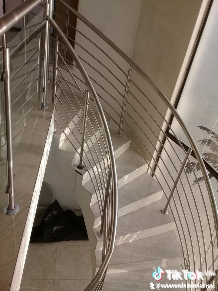 Curved interior staircase with glass balustrade